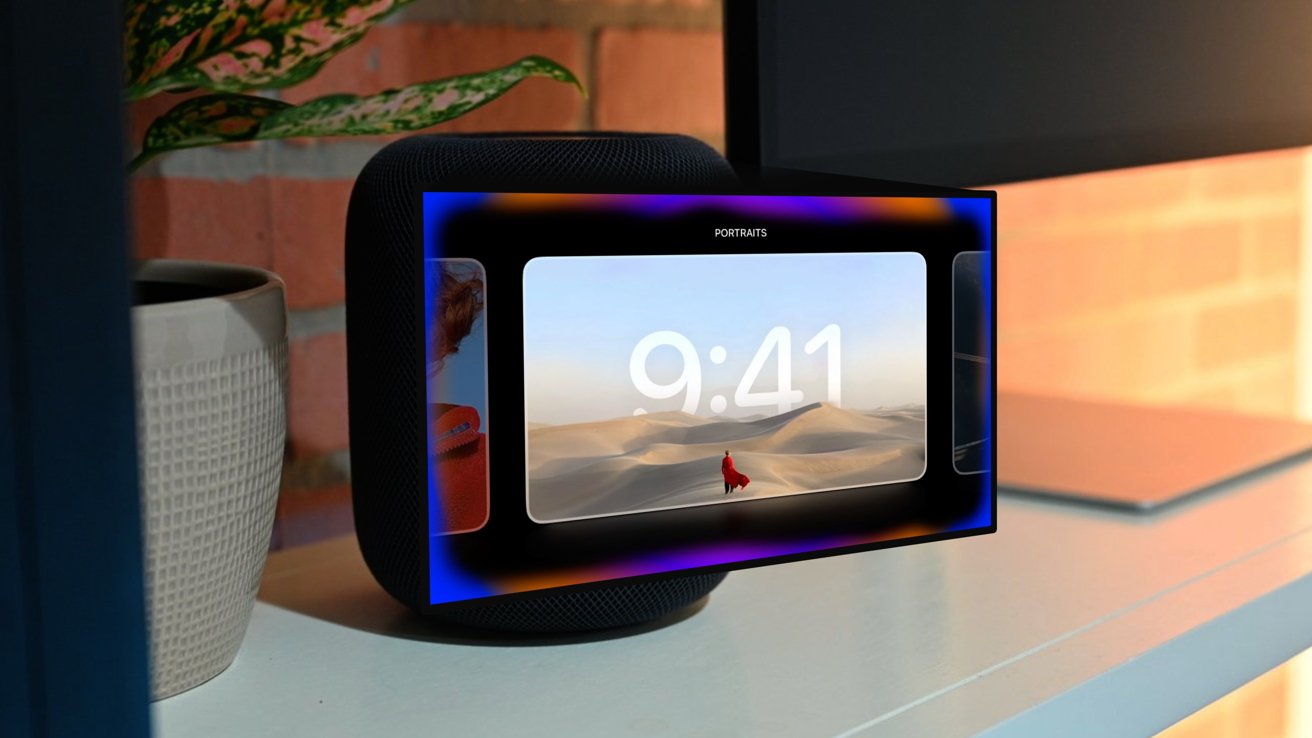 Smart speaker with digital display showing desert scene and time reading 9:41, placed on a shelf with a plant and a part of a laptop visible.