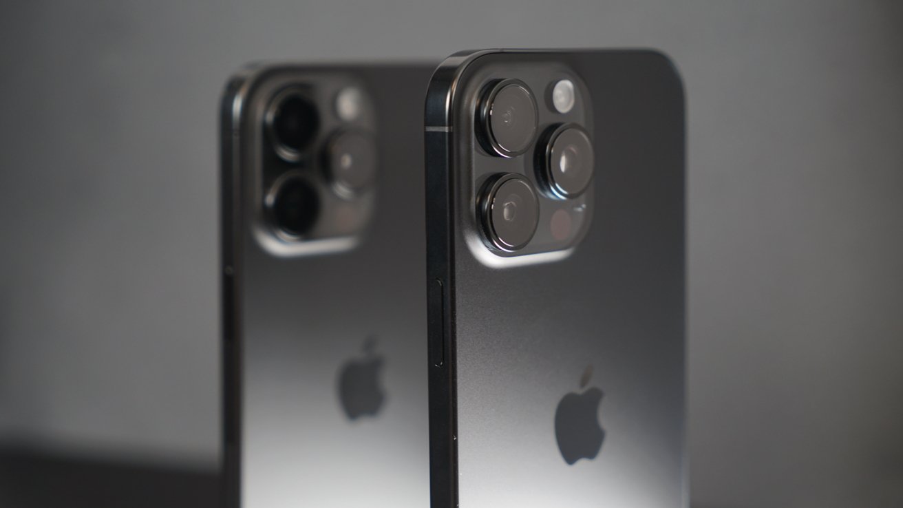 The iPhone 15 Pro and iPhone 16 Pro with multiple camera lenses on a reflective surface, each displaying an apple logo.