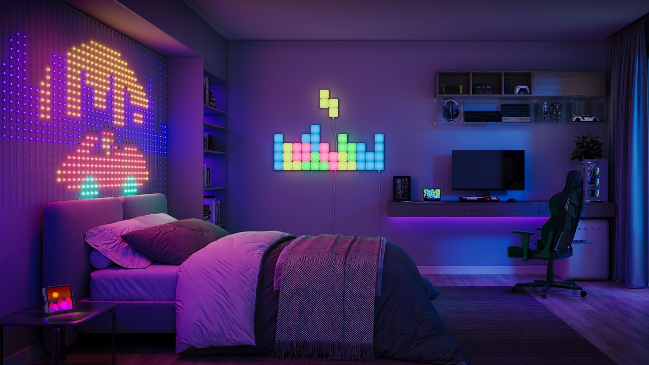 A dimly lit bedroom outfitted with an array of colorful smart lights on the wall, on the desk, and behind the bed