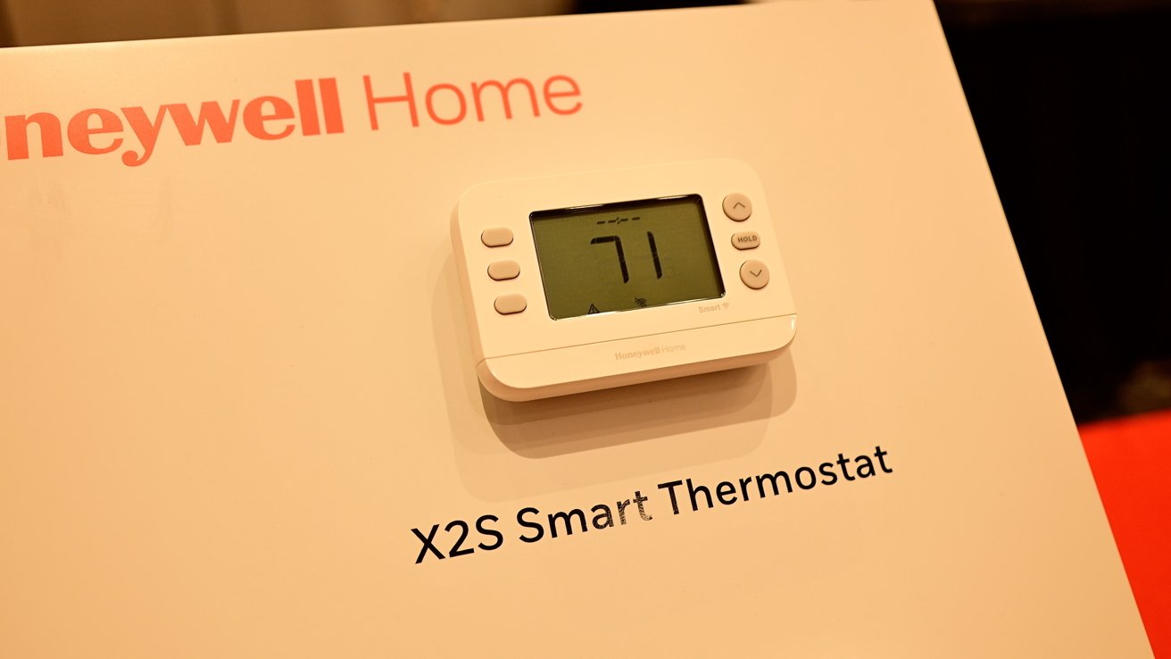 Honeywell Home X2S Smart Thermostat display showing 71 degrees mounted on a white board.