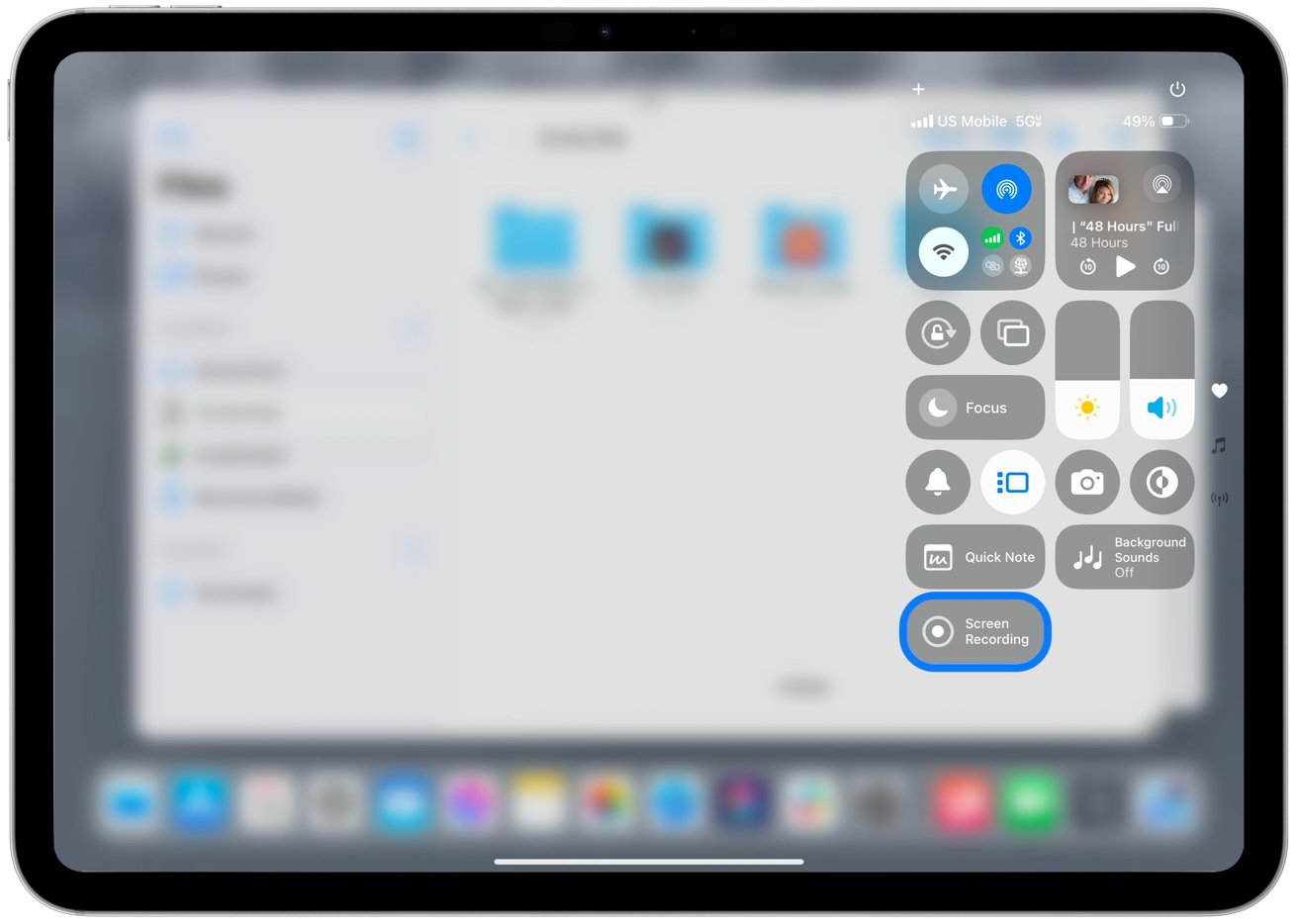 iPad screen showing blurred background with visible control center panel on the right, displaying various icons and buttons for settings and features.