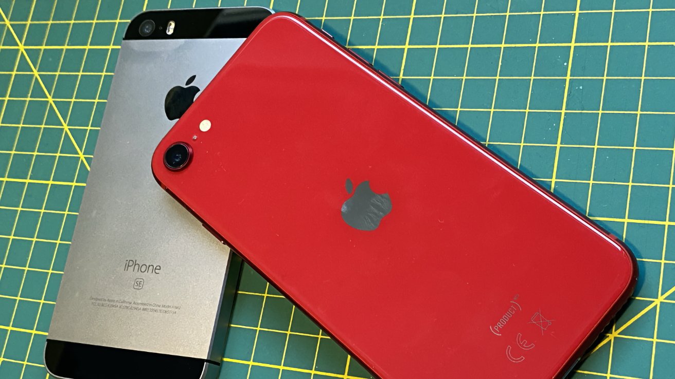 Two iPhones on a green grid cutting mat; one is red, and the other is silver and black.