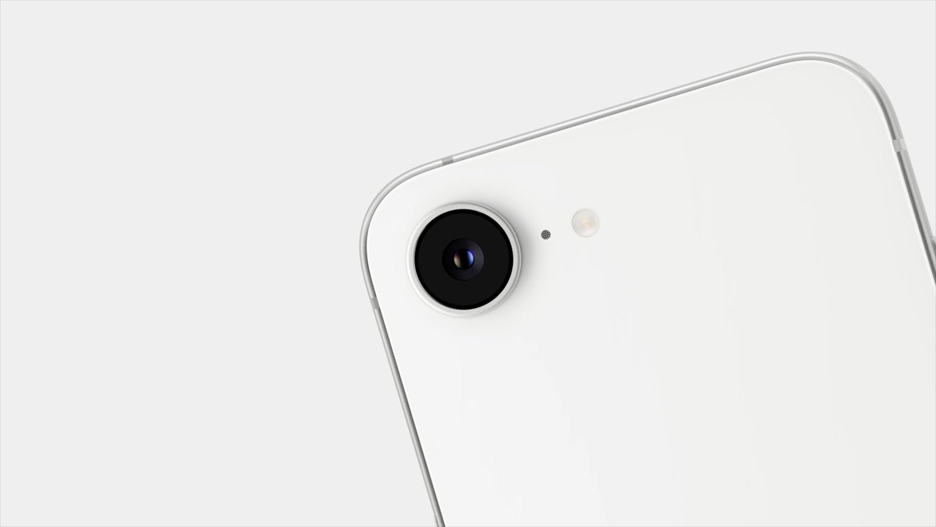 Close-up of a white smartphone's rear camera, flash and microphone, with a sleek design and rounded edges against a light background.