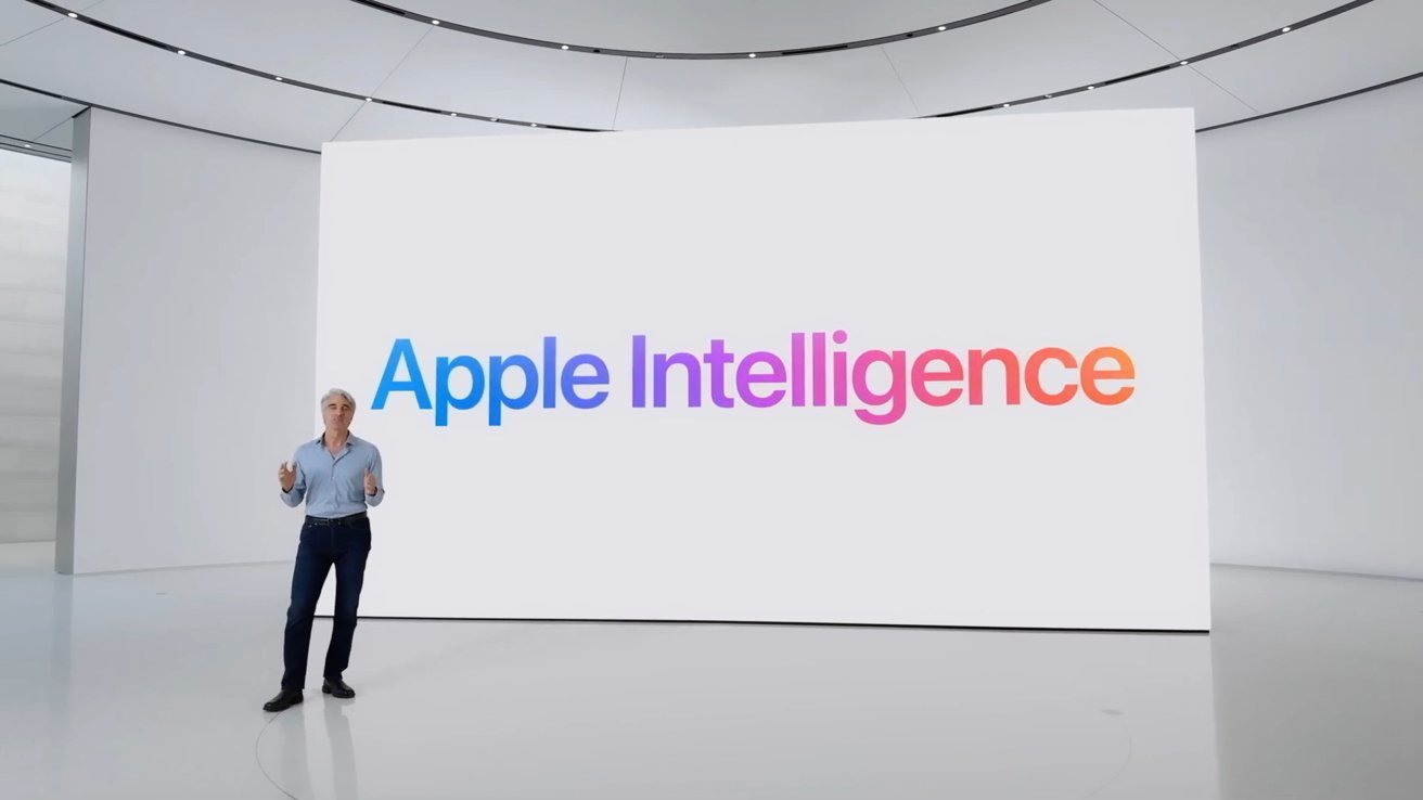 Person standing on a stage in a modern auditorium, with the words 'Apple Intelligence' displayed in colorful gradient on a large screen.