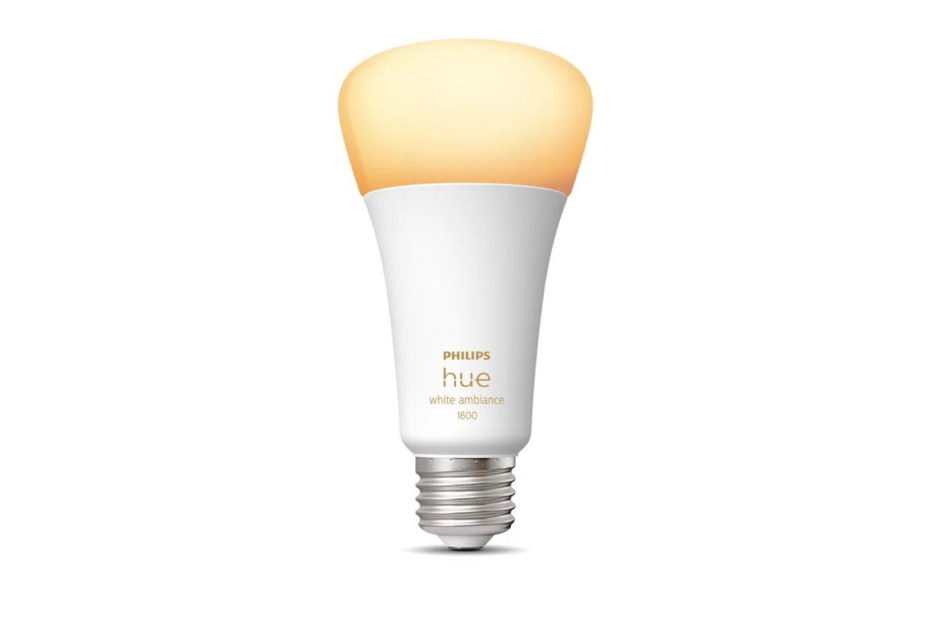 Smart light bulb with a warm, soft orange glow on top, white base, and metal screw fitting against a white background.