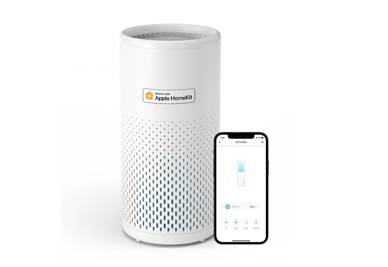 White cylindrical air purifier with perforated design, labeled compatible with Apple HomeKit. A smartphone displaying air purifier controls sits beside it, showing filter life and settings.