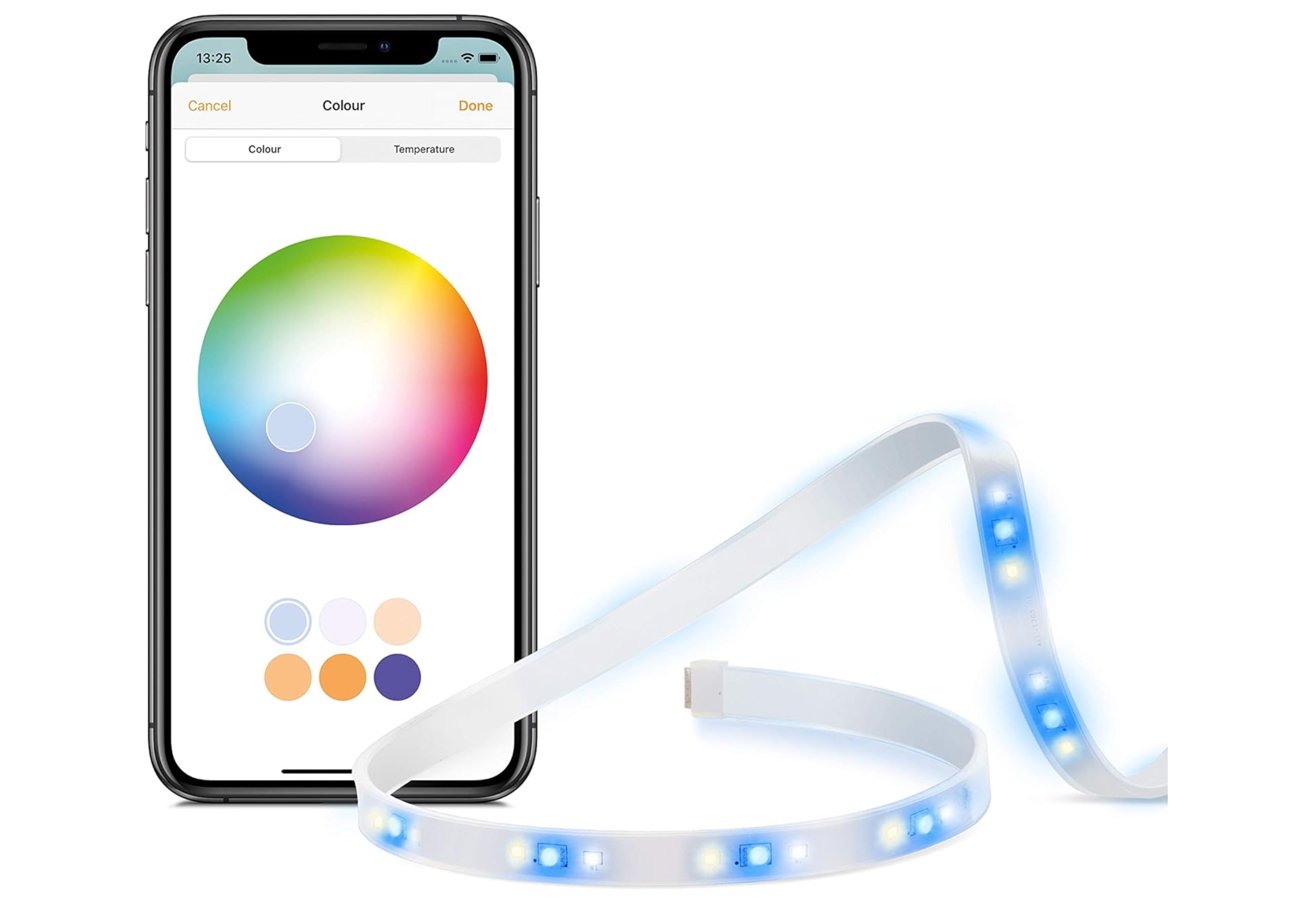 Smartphone displaying color selection app next to a flexible LED light strip glowing with blue and white lights.