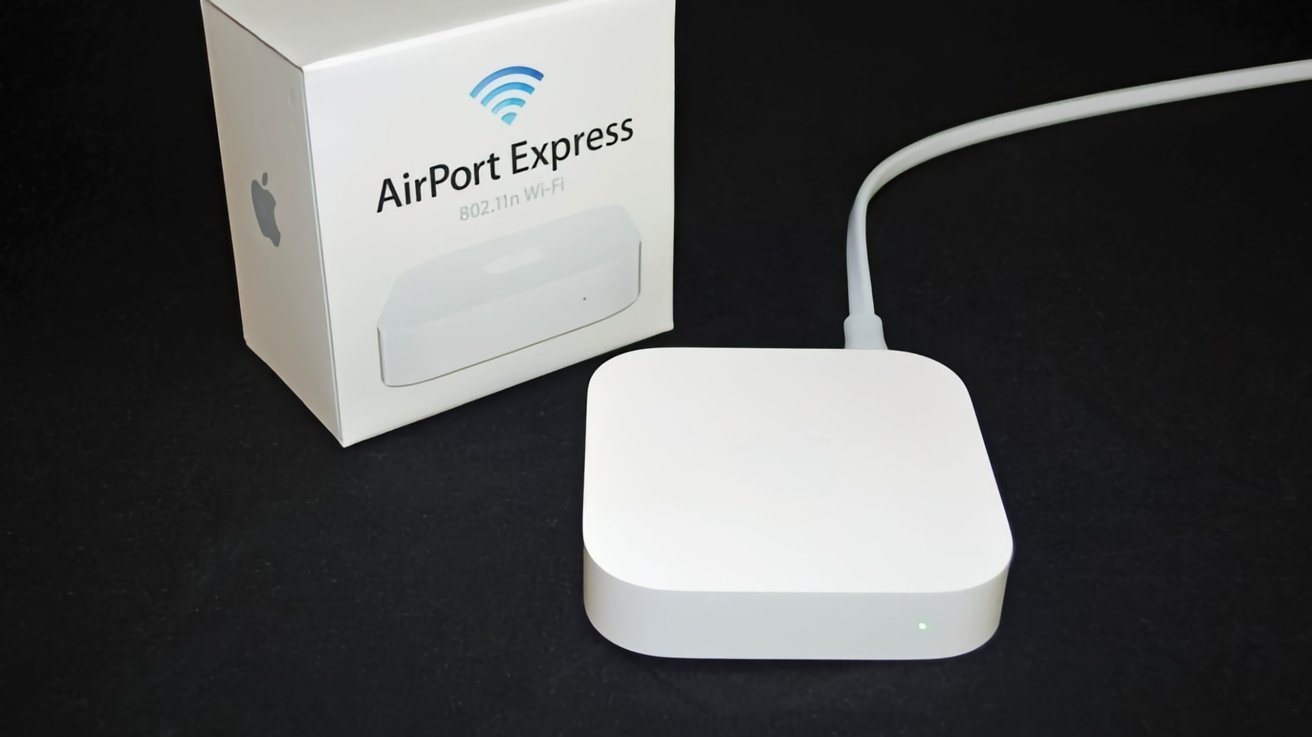 White Apple AirPort Express router with packaging displaying product name and Wi-Fi symbol on a black background.