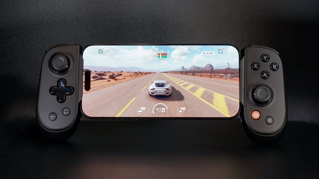 Smartphone mounted in a game controller displays a racing game with a car on a desert road.
