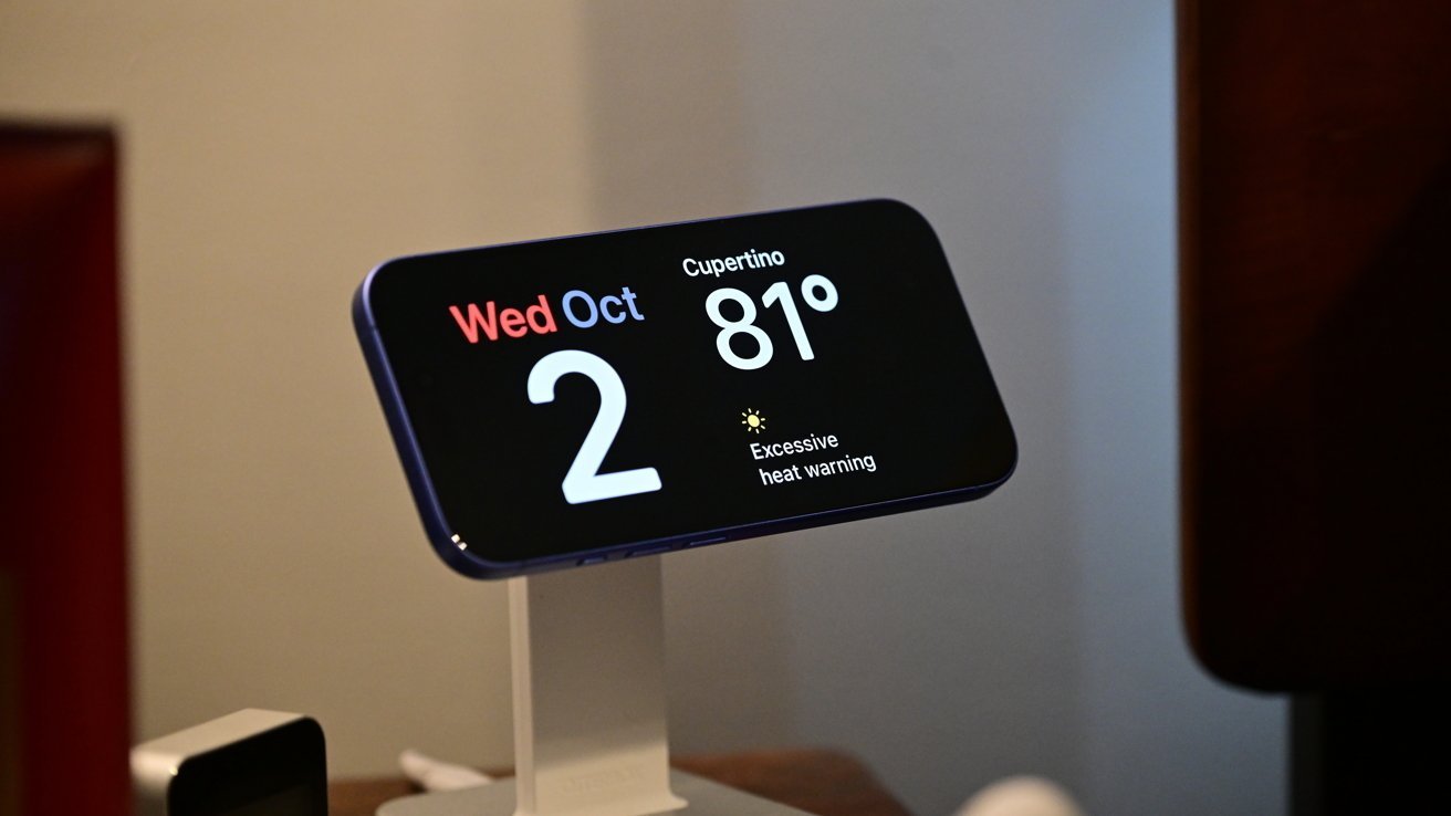Smartphone displaying date, October 2nd, Wednesday in red and blue, with current temperature 81F in Cupertino, and an excessive heat warning sign.