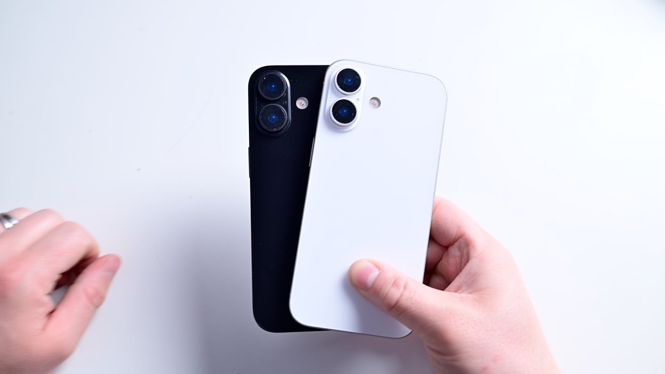 Two hands holding black and white smartphones with dual cameras on a white background.