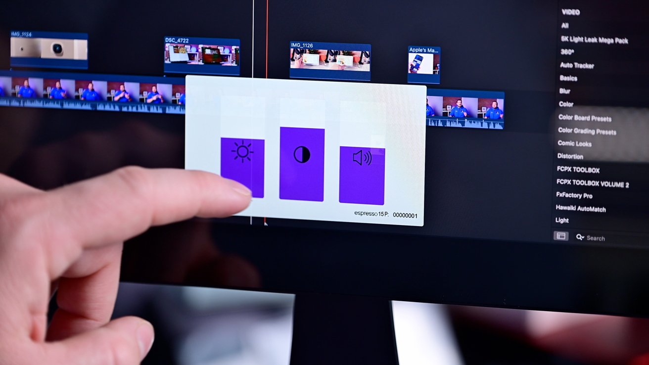 A person adjusts brightness, contrast, and volume on a computer display interface, with various video editing elements and menus visible in the background.