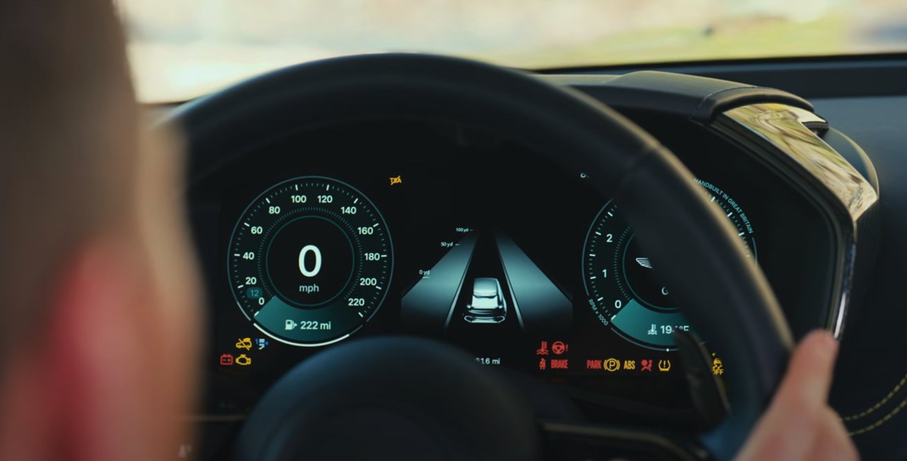 Driver's perspective of a car dashboard showing speedometer, digital display with car graphic, indicator lights, and road layout.