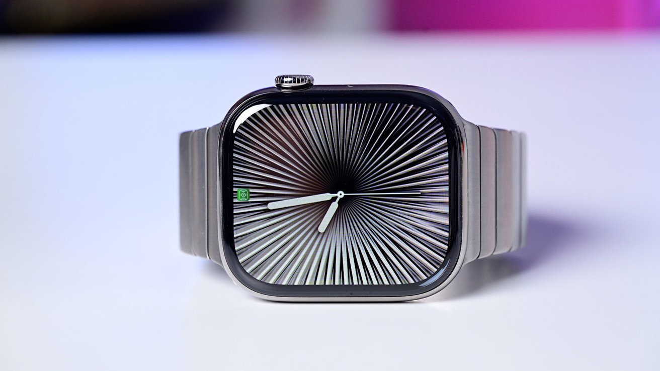 Apple Watch Series 10 with a metallic band displaying a mesmerizing black and white radial pattern on its screen.