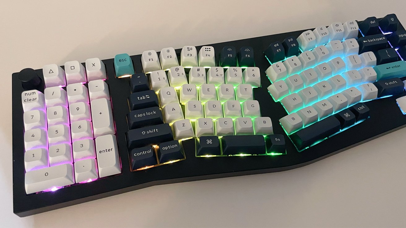 Mechanical keyboard with white and blue keys, featuring colorful backlighting in hues of green, blue, and purple.