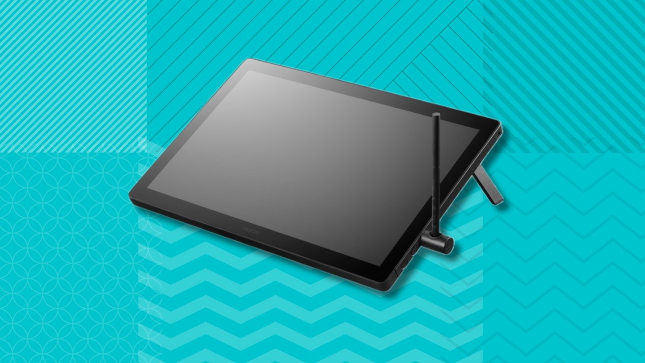 Wacom Cintiq pen display with a pen on a geometric turquoise background featuring stripes and circles.