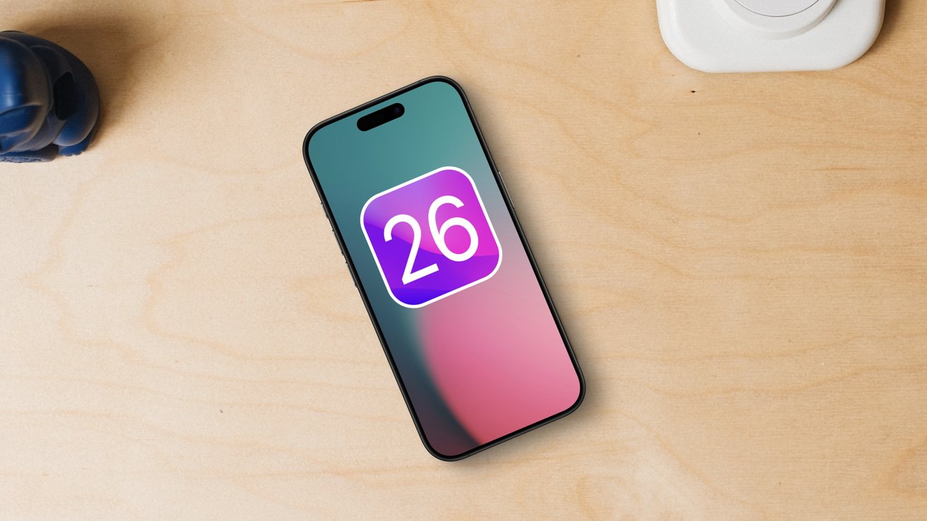 Smartphone on wooden table, displaying a colorful screen with a '26' icon, next to a small blue object.