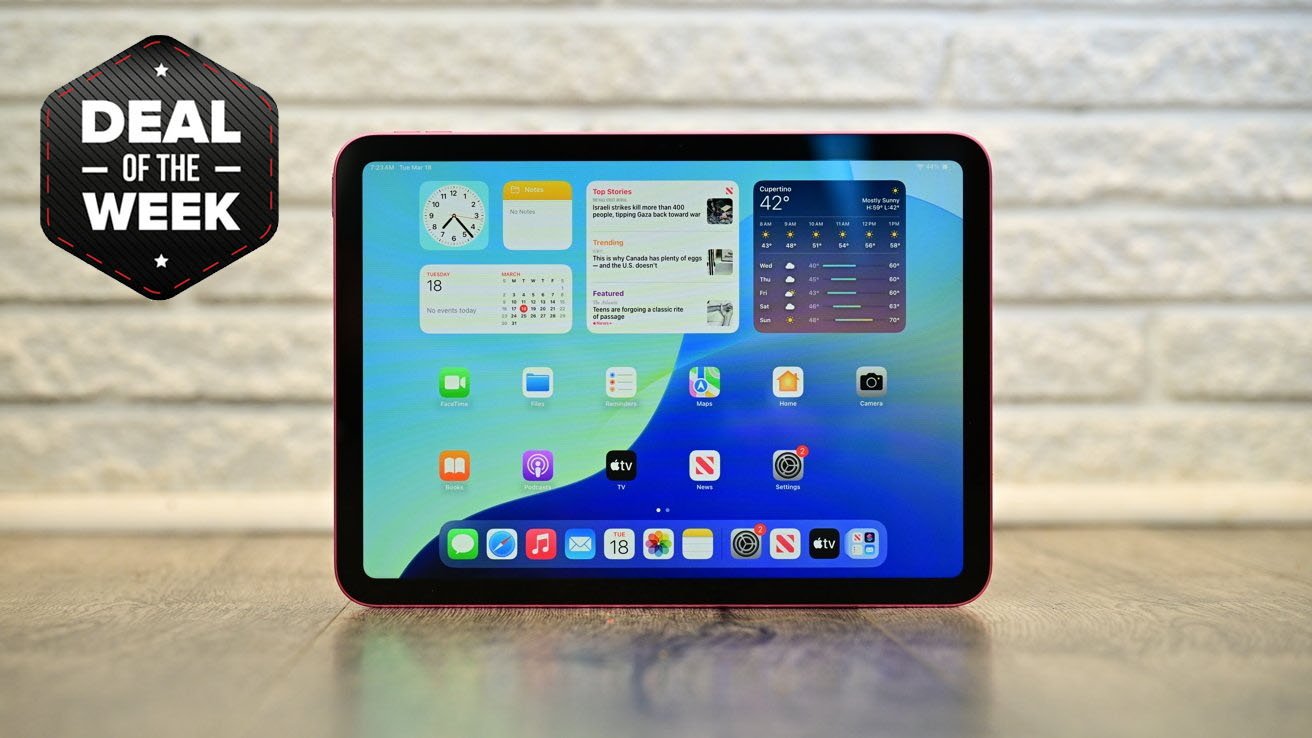iPad 11 on a wooden surface displaying apps and widgets. Nearby, a banner reads 'Deal of the Week' on a textured white brick background.