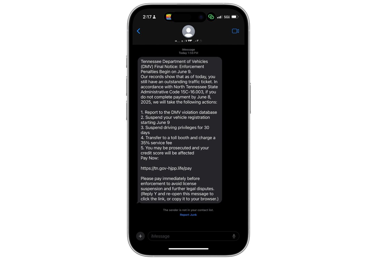 Phone displaying a suspicious text claiming to be from the Tennessee DMV, warning of unpaid ticket penalties and directing to a link for payment.