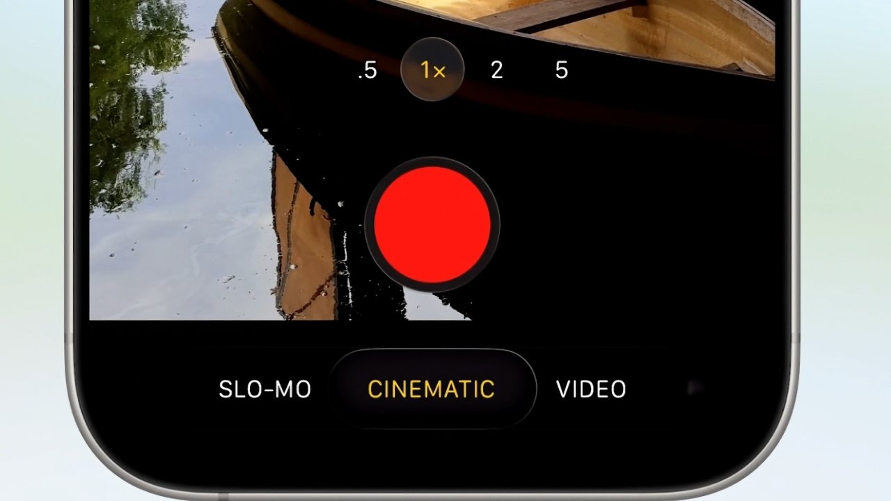 Smartphone screen showing camera interface with zoom options, recording button, and mode selection including Slo-Mo, Cinematic, Video. A reflection of a boat and trees is visible.
