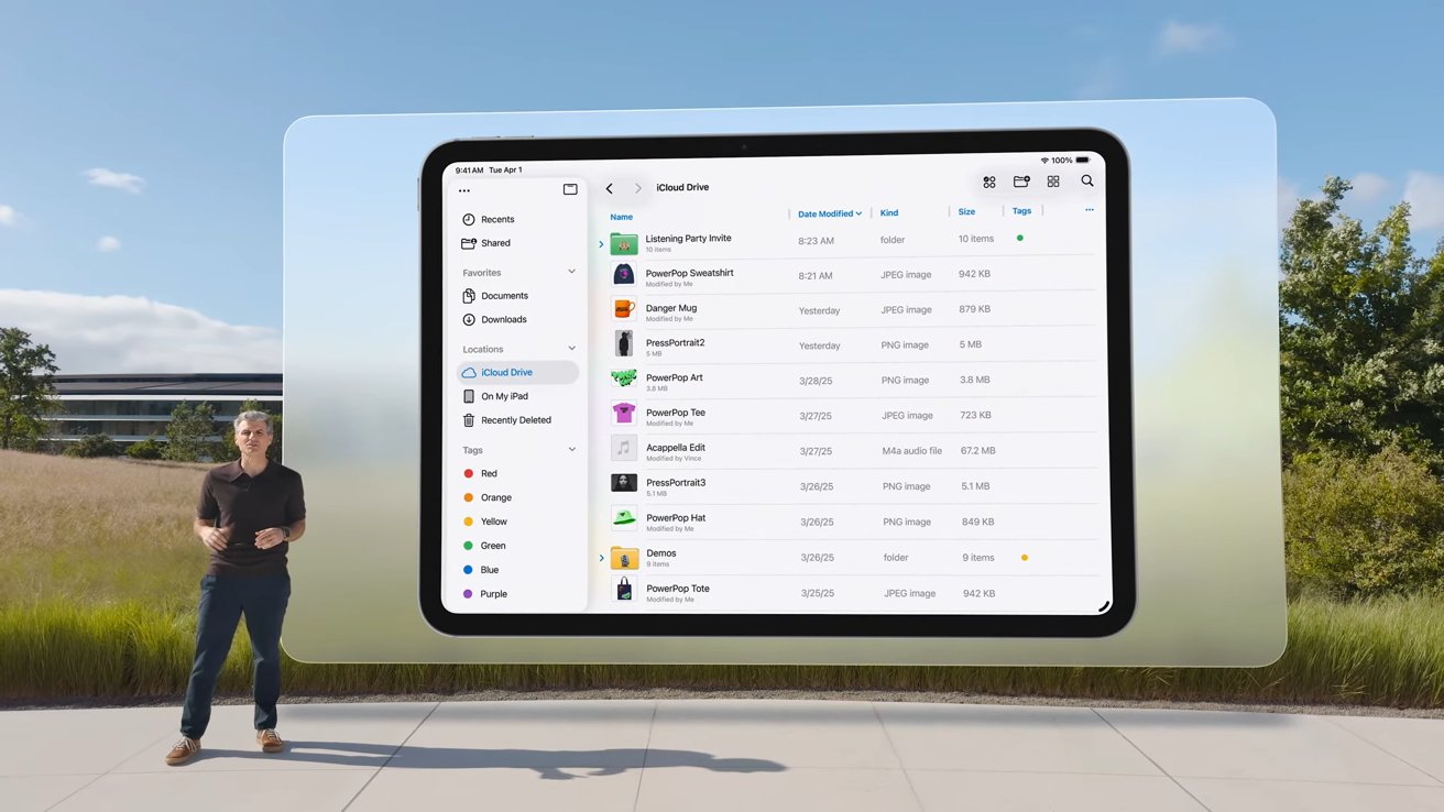 A person stands outdoors next to a large floating tablet screen displaying a file management interface against a backdrop of grass and trees.