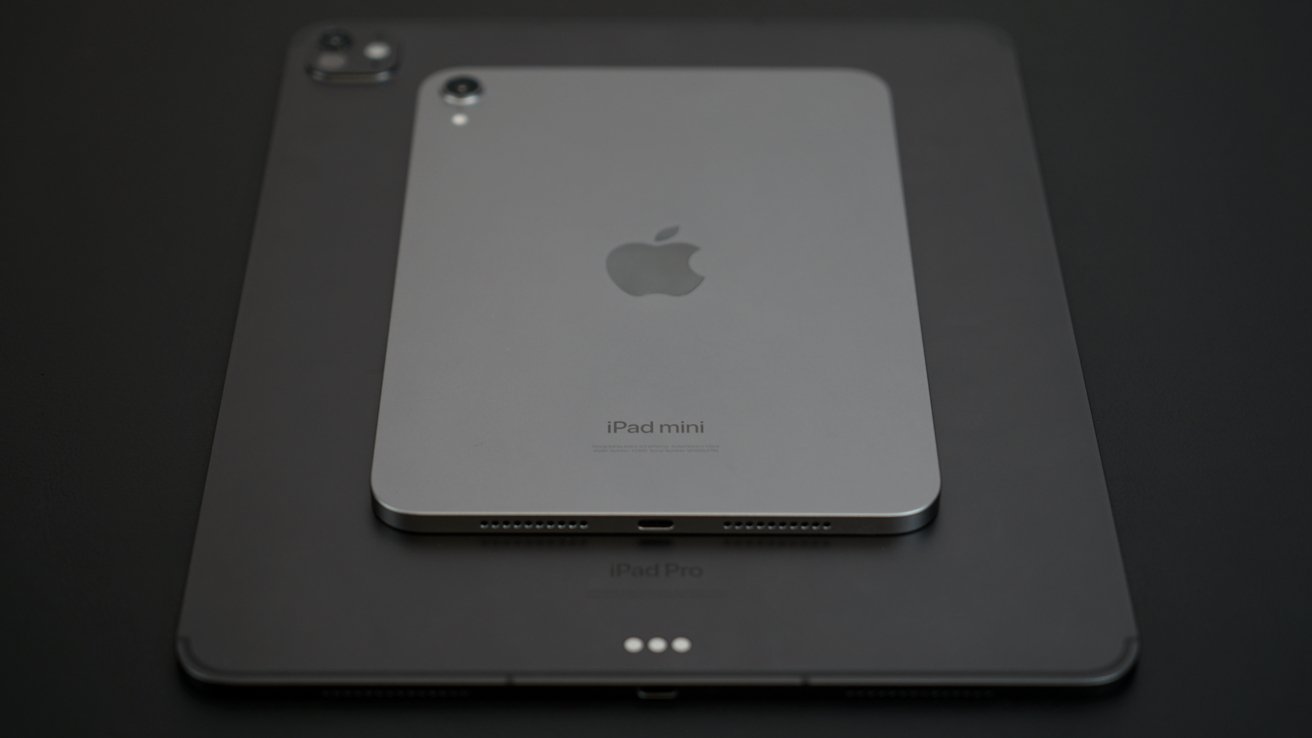 iPad mini placed on top of an iPad Pro, viewed from above, with a dark background.