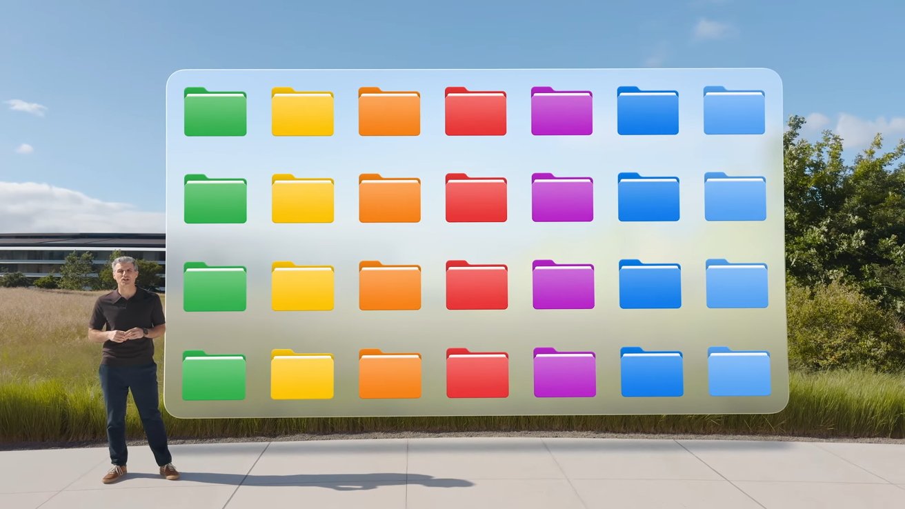 A person stands outdoors beside a large display of colorful folder icons arranged in rows, with a modern building in the background.