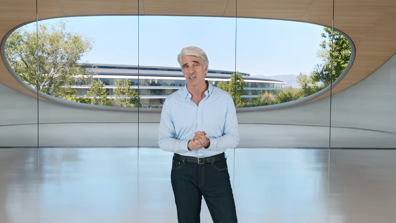 Person with gray hair and light blue shirt stands in a modern building with large windows overlooking greenery and a futuristic structure.