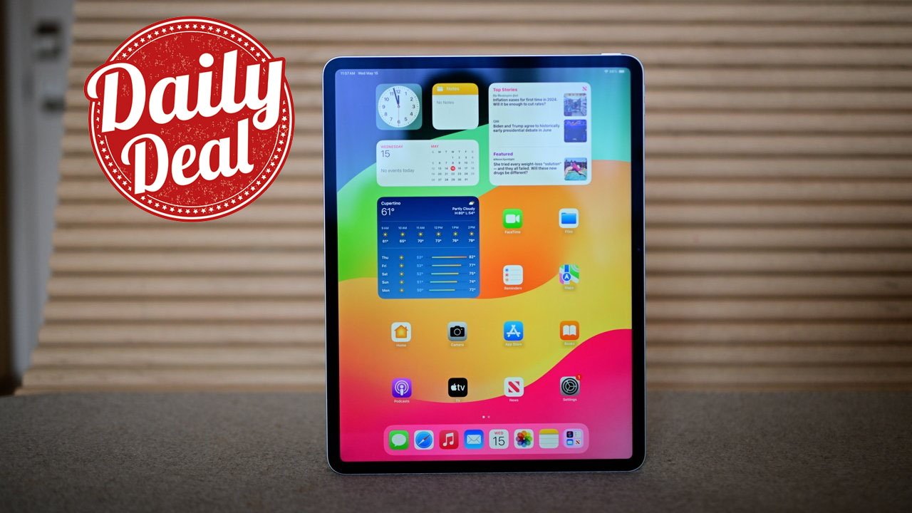 Apple iPad with colorful home screen displaying apps and widgets on a table, red Daily Deal badge on left, striped background.