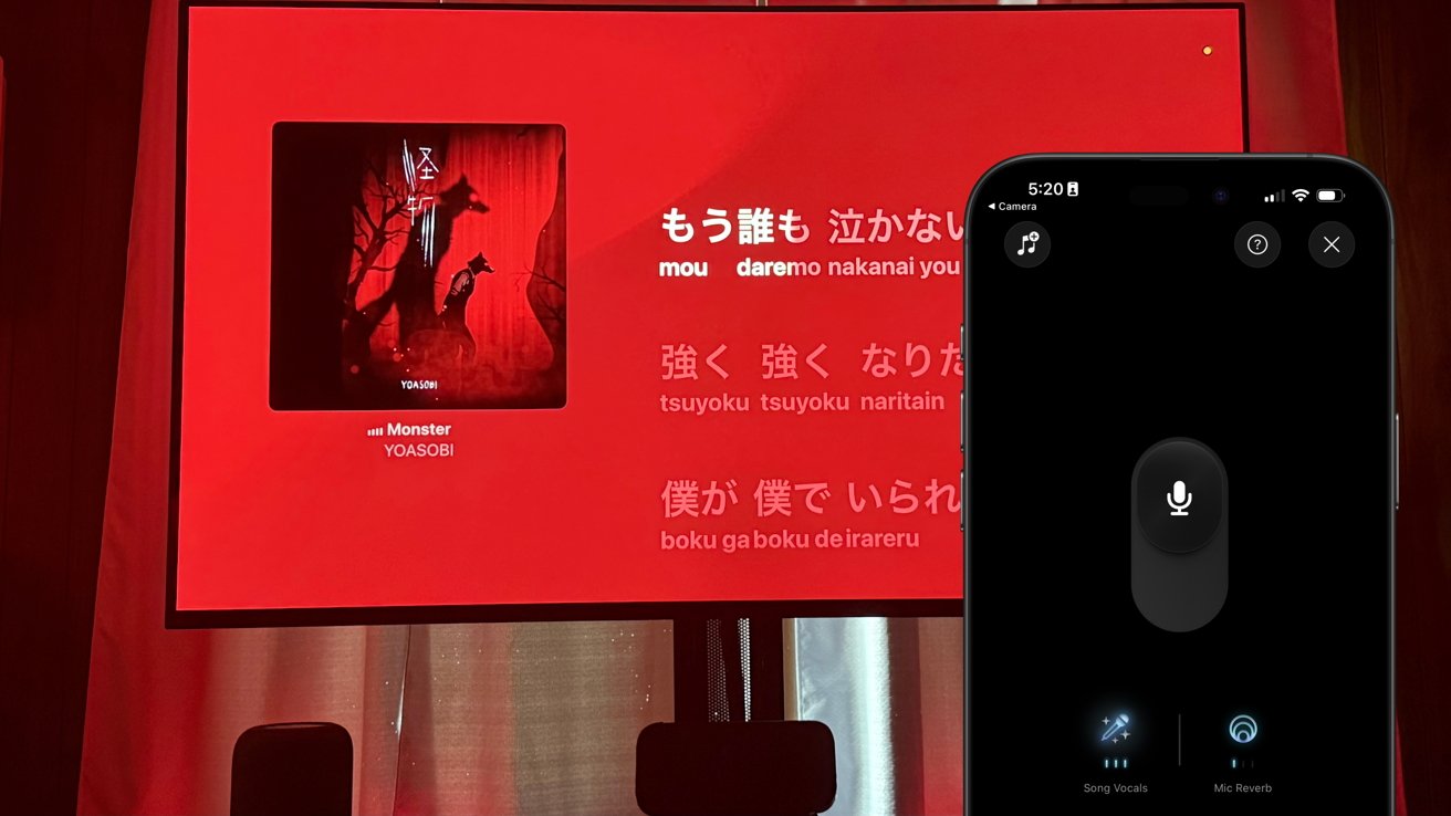 Karaoke setup displaying Japanese lyrics on a TV screen with a song cover art. A smartphone shows a digital microphone interface with options for song vocals and mic reverb.