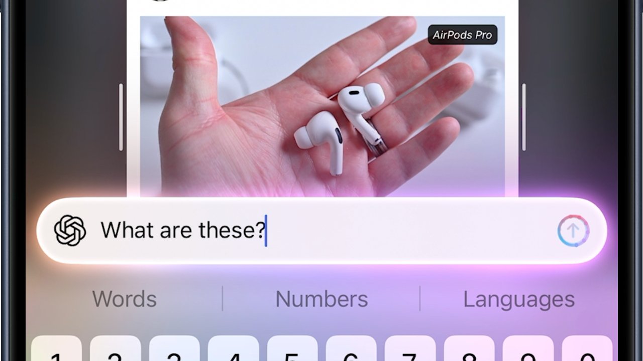 A hand holds wireless earbuds over a phone screen displaying a keyboard and a query asking, 'What are these?'
