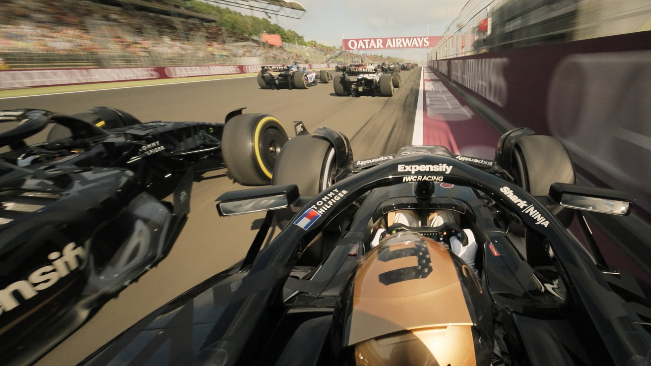 Race cars competing on a track, surrounded by blurred motion and advertising banners, with a focus on a sleek black vehicle in the foreground.