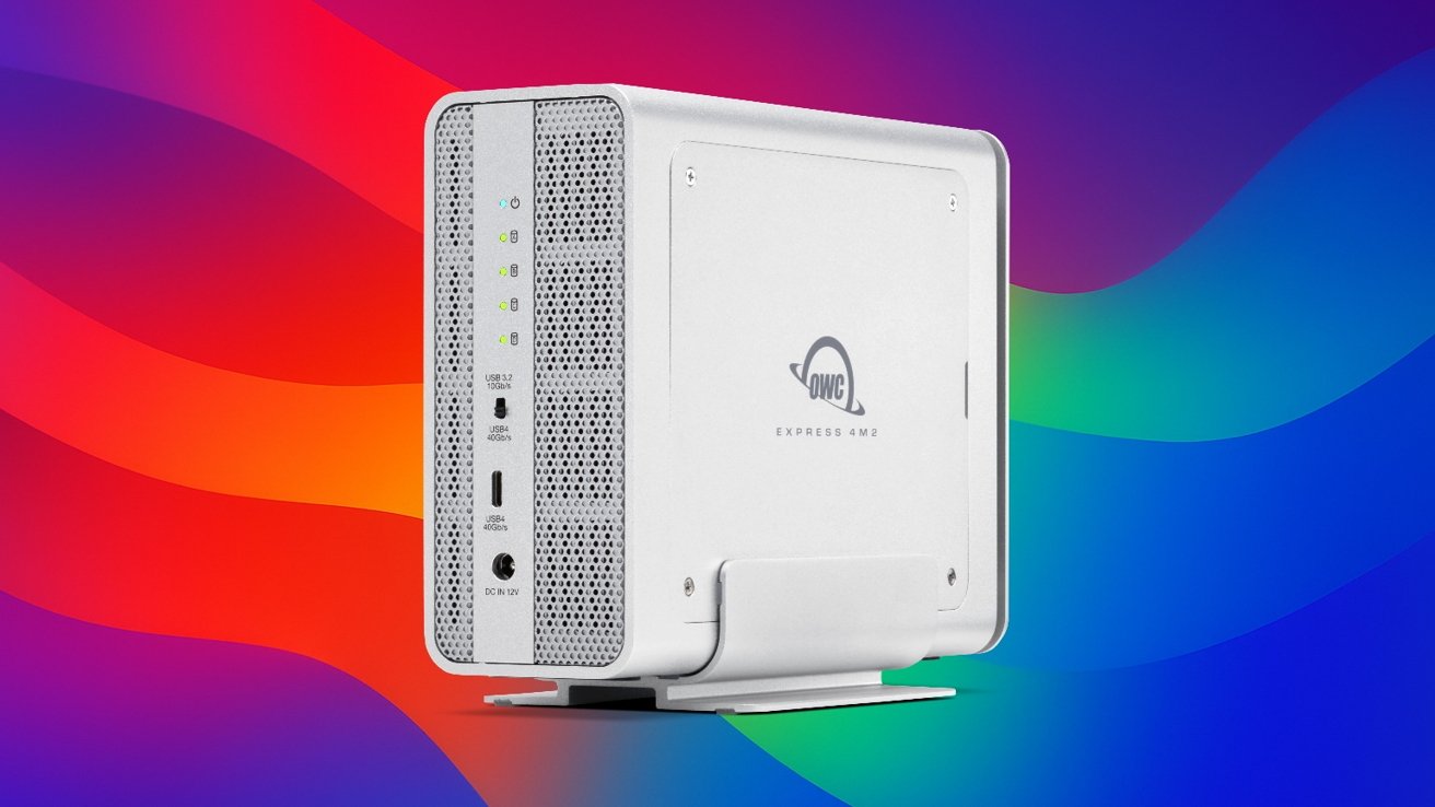 Silver external hard drive enclosure with OWC logo, ventilation holes, USB ports, and status lights, set against a vibrant rainbow gradient background.