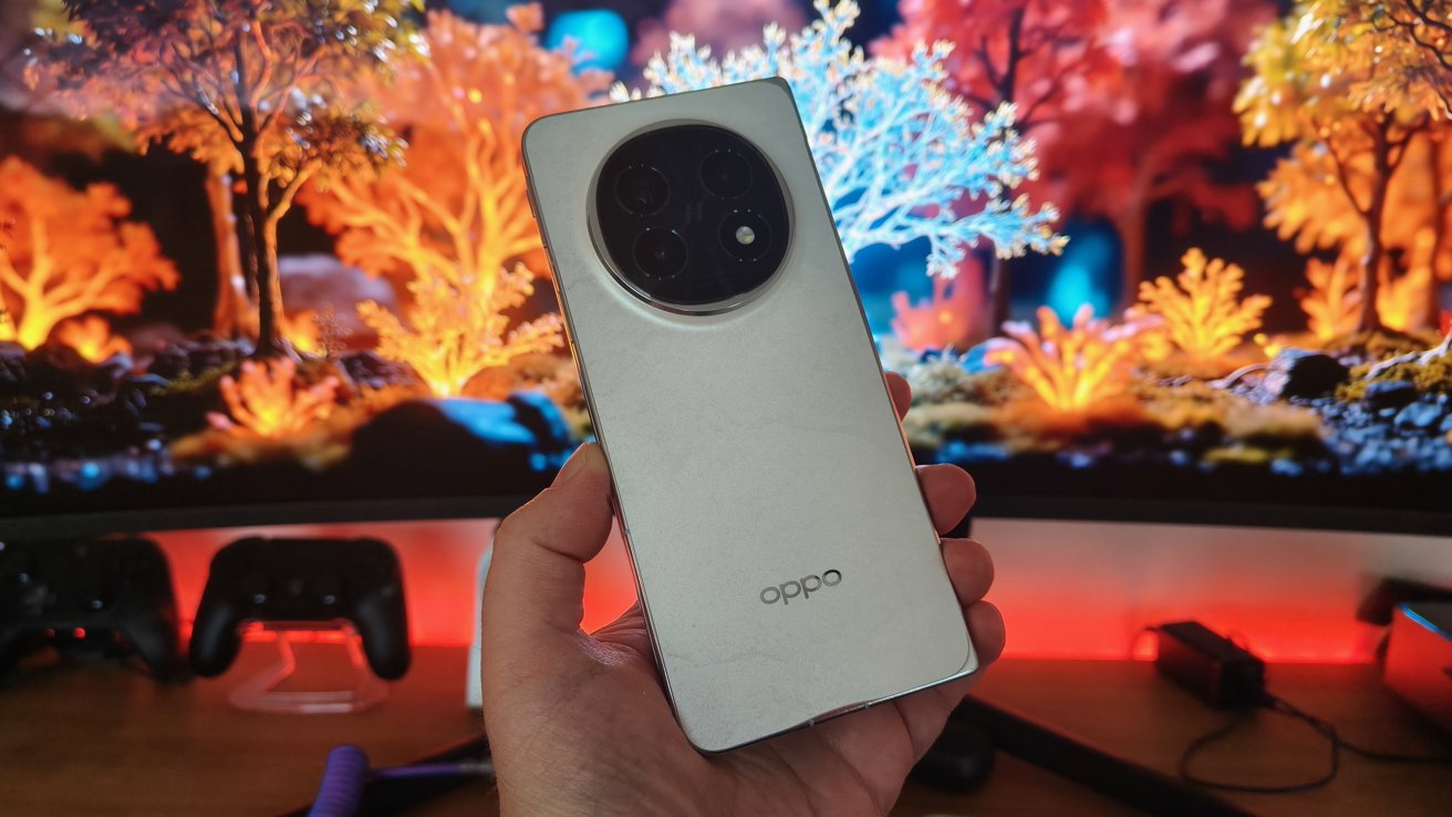 A hand holds a silver smartphone with a circular camera module, against a vibrant, colorful background of illuminated, abstract trees.