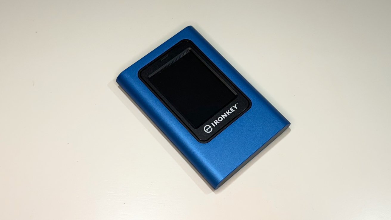 Blue portable hard drive with a small rectangular screen and 'IronKey' logo on a white surface.