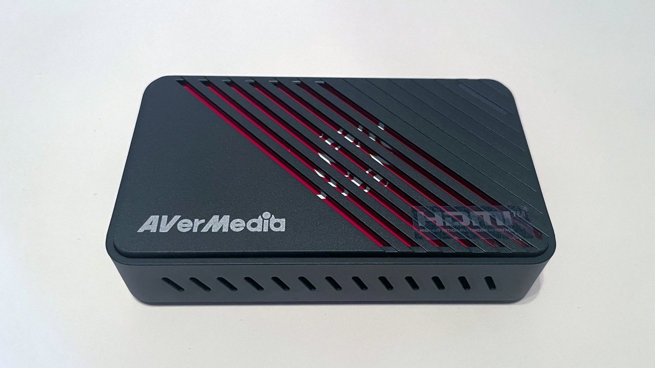 A black, rectangular electronic device with diagonal red vent lines, featuring the AVerMedia and HDMI logos.