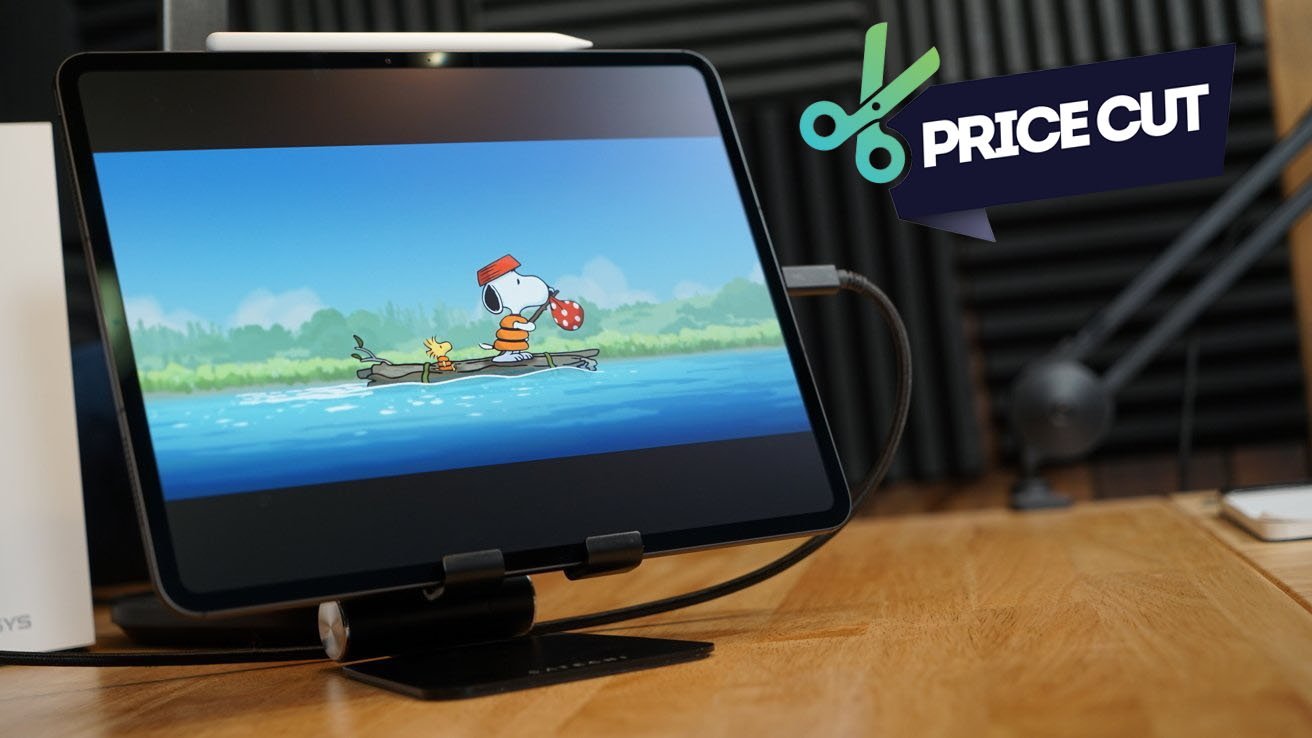 iPad Pro displaying cartoon of Snoopy and Woodstock, with 'Price Cut' label, on a wooden table.