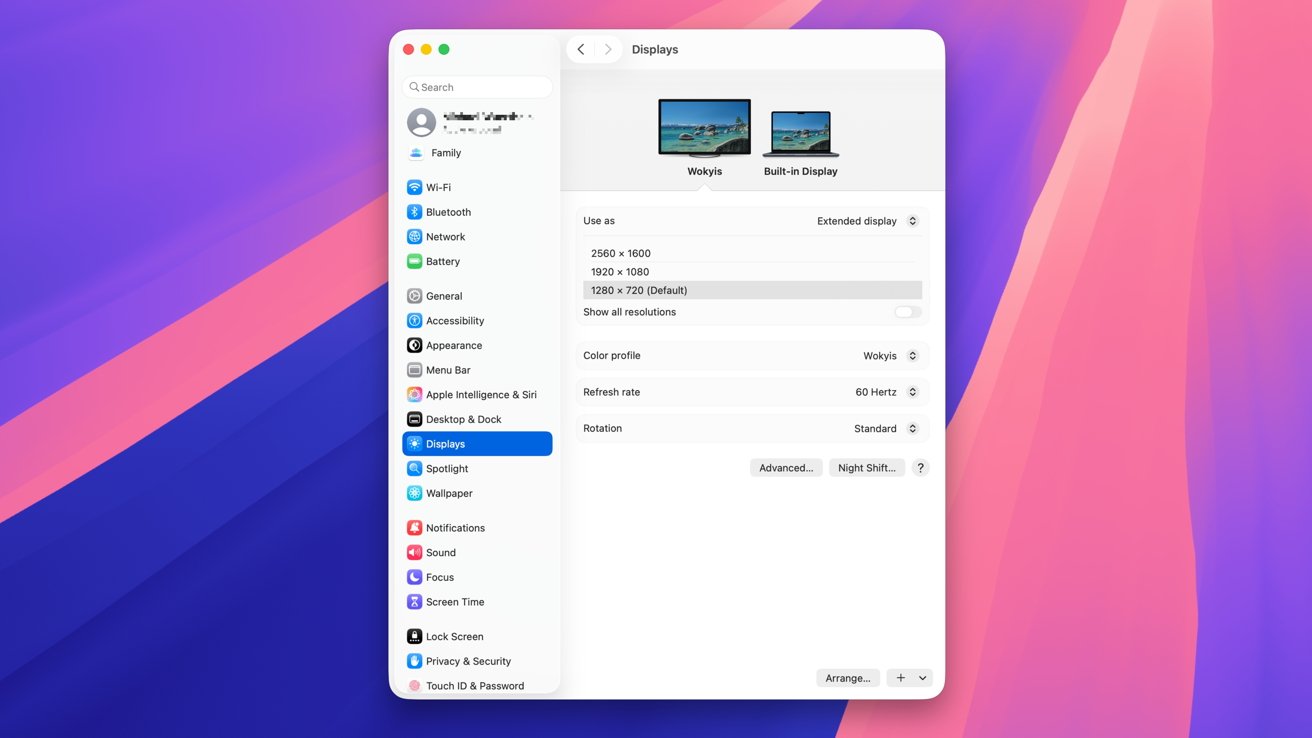 Computer display settings window showing two monitors resolution options color profile and refresh rate on a vibrant pink and blue gradient background