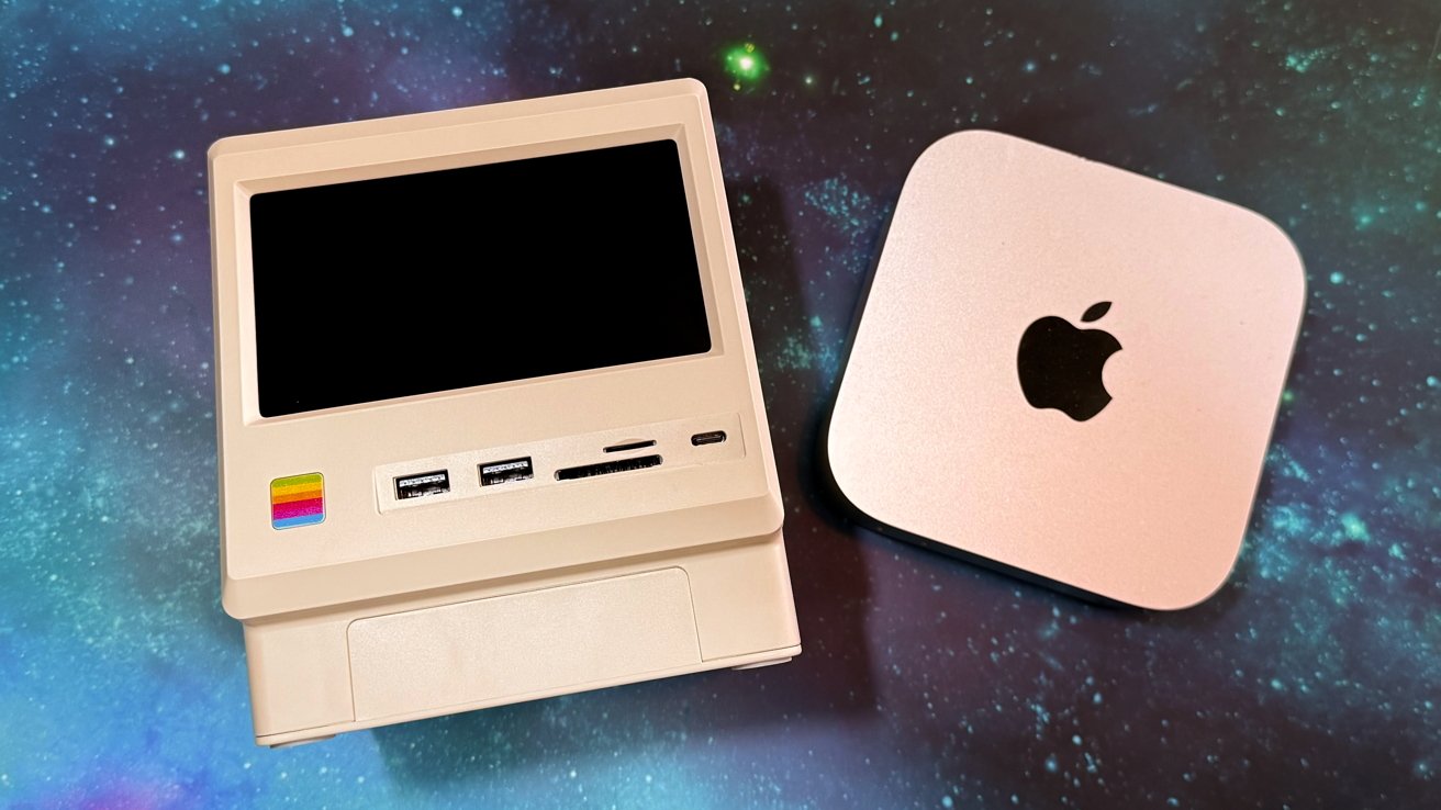 Image: https://photos5.appleinsider.com/gallery/64602-134608-Wokyis-M5-review-4-xl.jpg Small retro-style computer with various ports next to a compact square device with an apple logo set on a galaxy-patterned background