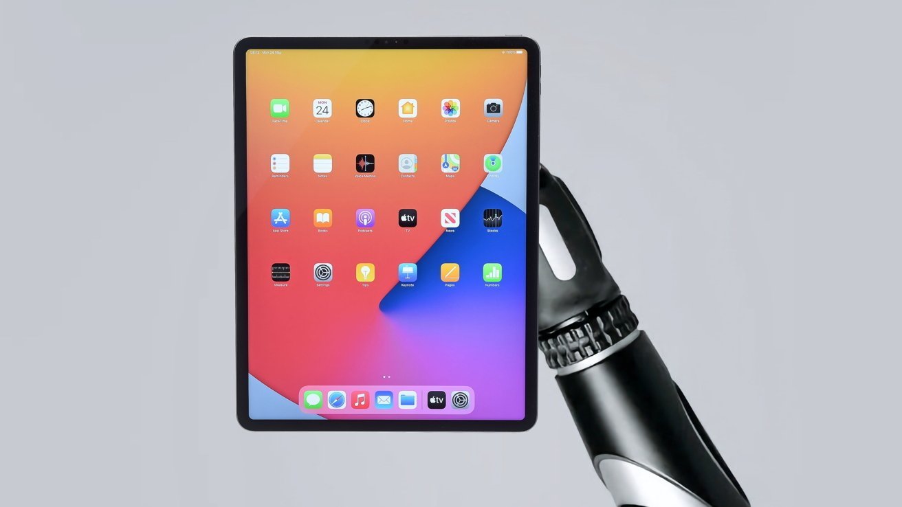 A robotic hand holds a tablet with a colorful screen displaying app icons, set against a light gray background.