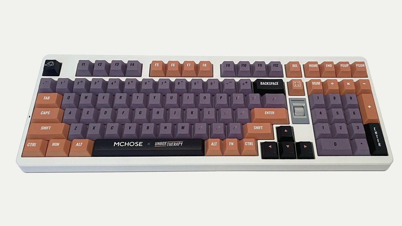 Colorful mechanical keyboard with purple, orange, and black keys, white base, and a silver scroll wheel. Branding indicates collaboration between two companies.