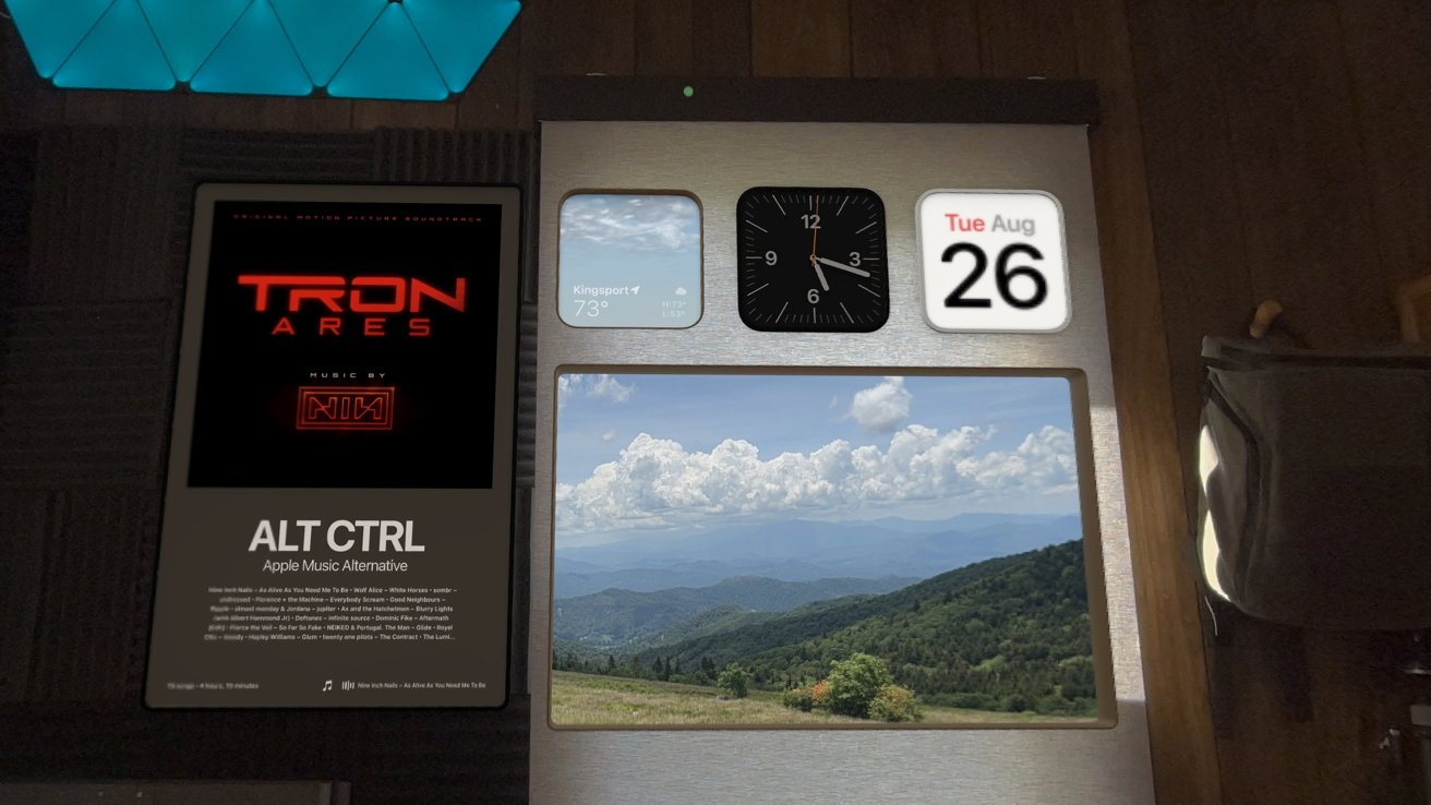 Digital dashboard with Tron Ares poster, weather in Kingsport at 73F, analog clock, calendar showing Tuesday 26th, and a mountain landscape photograph.