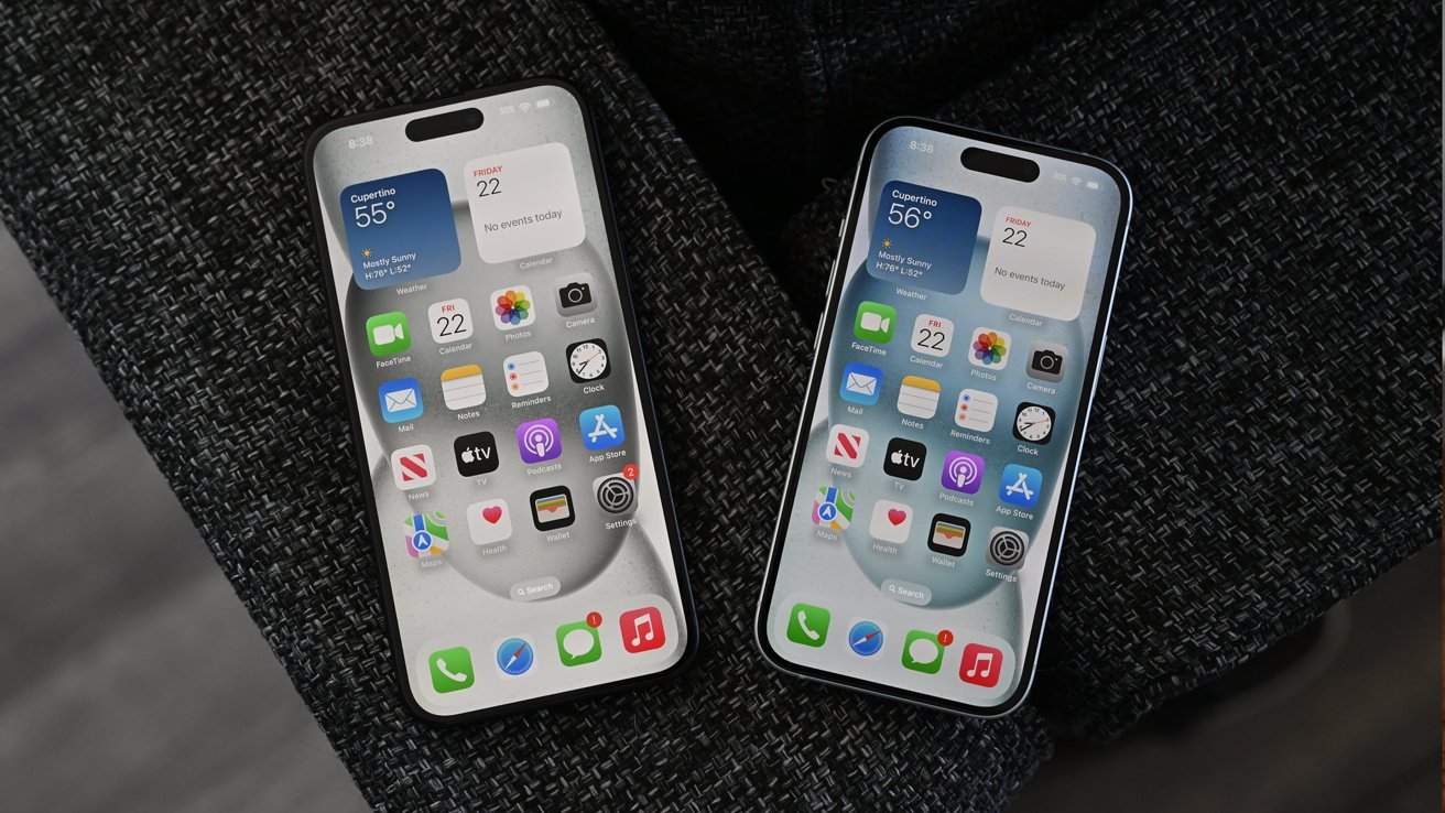 Two smartphones displaying home screens with weather, calendar, and app icons, placed on a dark textured fabric.