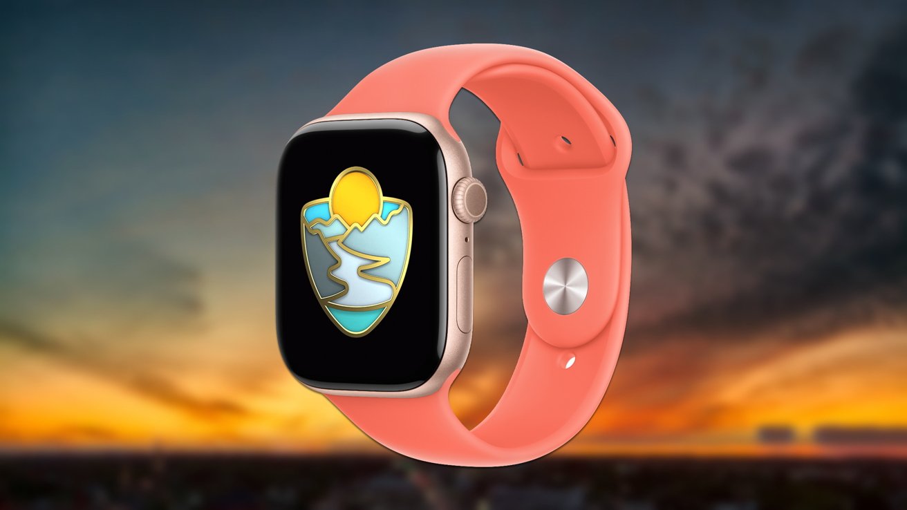 Smartwatch with a coral band displays a colorful mountain and sun emblem on its screen, set against a blurred sunset background.