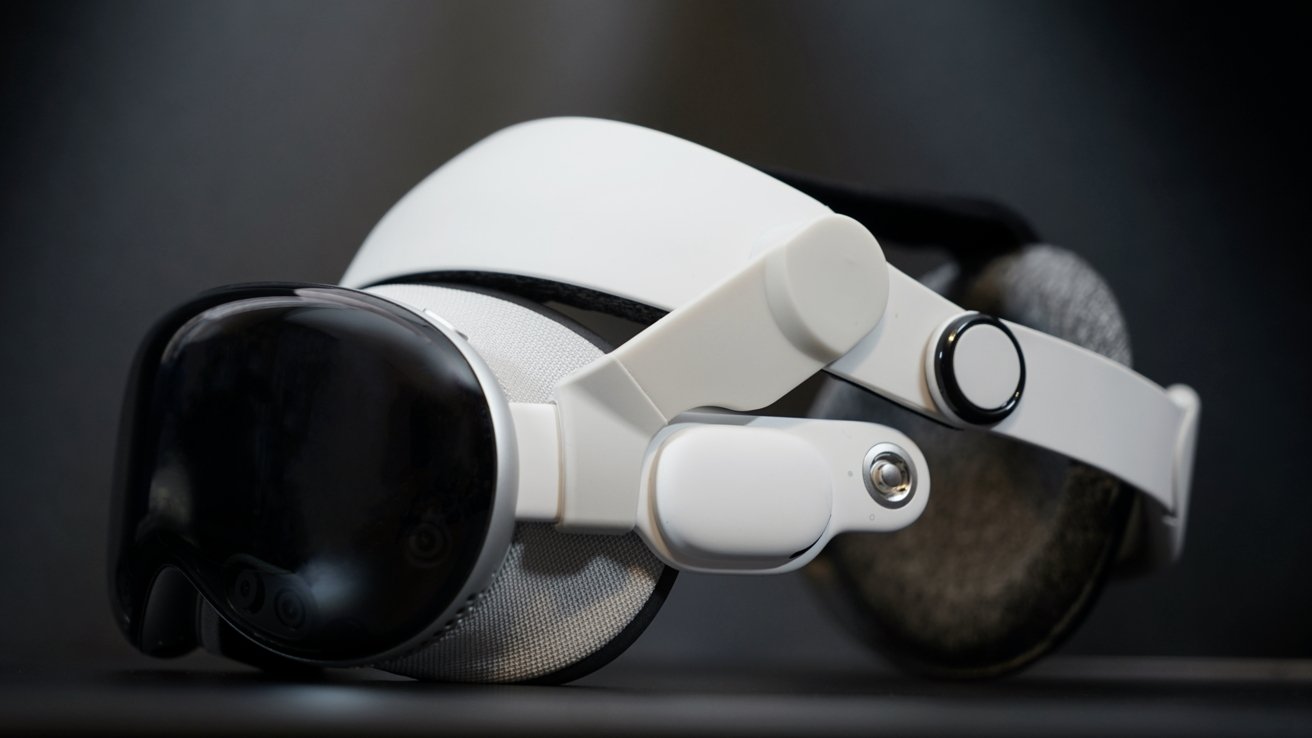White and black virtual reality headset with curved visor and adjustable straps, placed on a dark surface, showcasing sleek design and modern technology.
