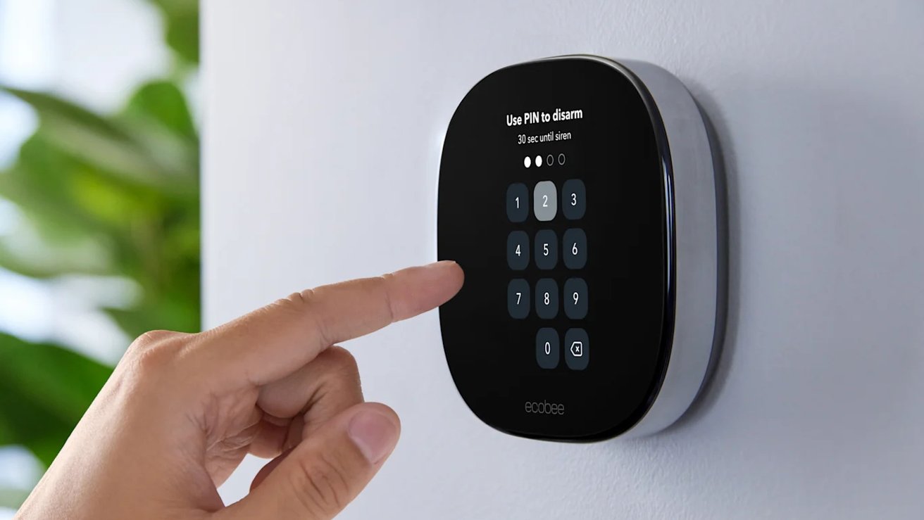 A hand entering a code onto a wall-mounted ecobee thermostat
