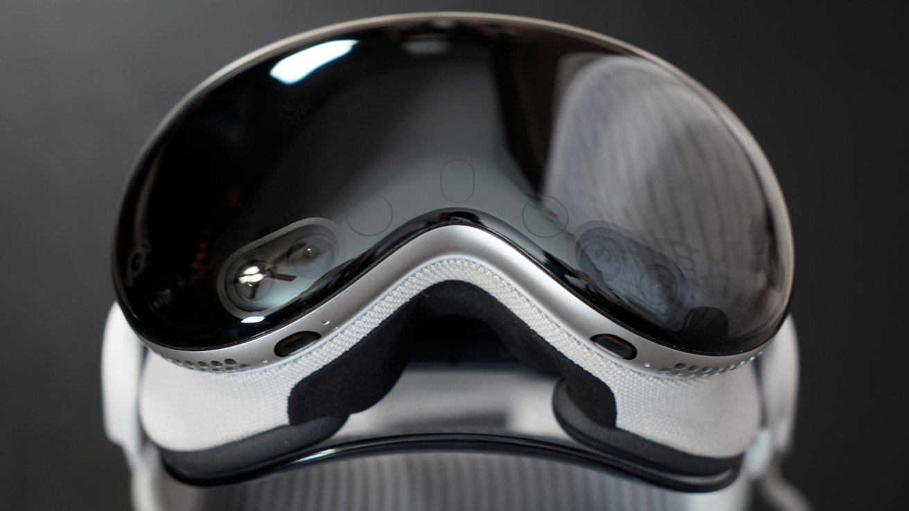 Close-up of a sleek, futuristic headset with a reflective, tinted visor on a dark background.