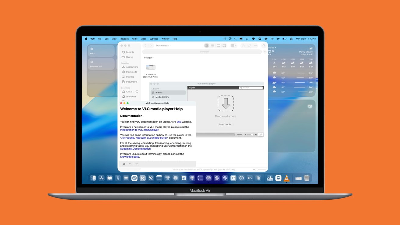 Open laptop displaying VLC media player window with help documentation, File Explorer, and weather widget on the desktop, against an orange background.