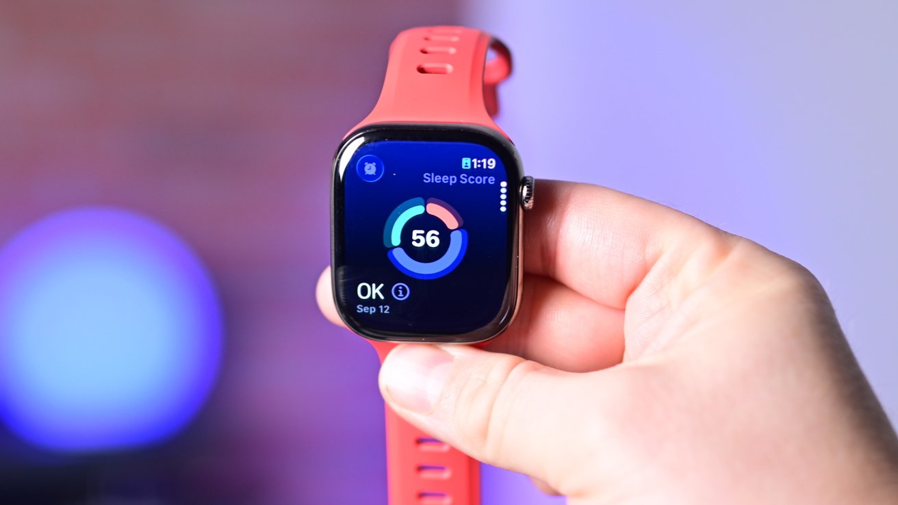 A hand holding an Apple Watch with a 56 score in the middle