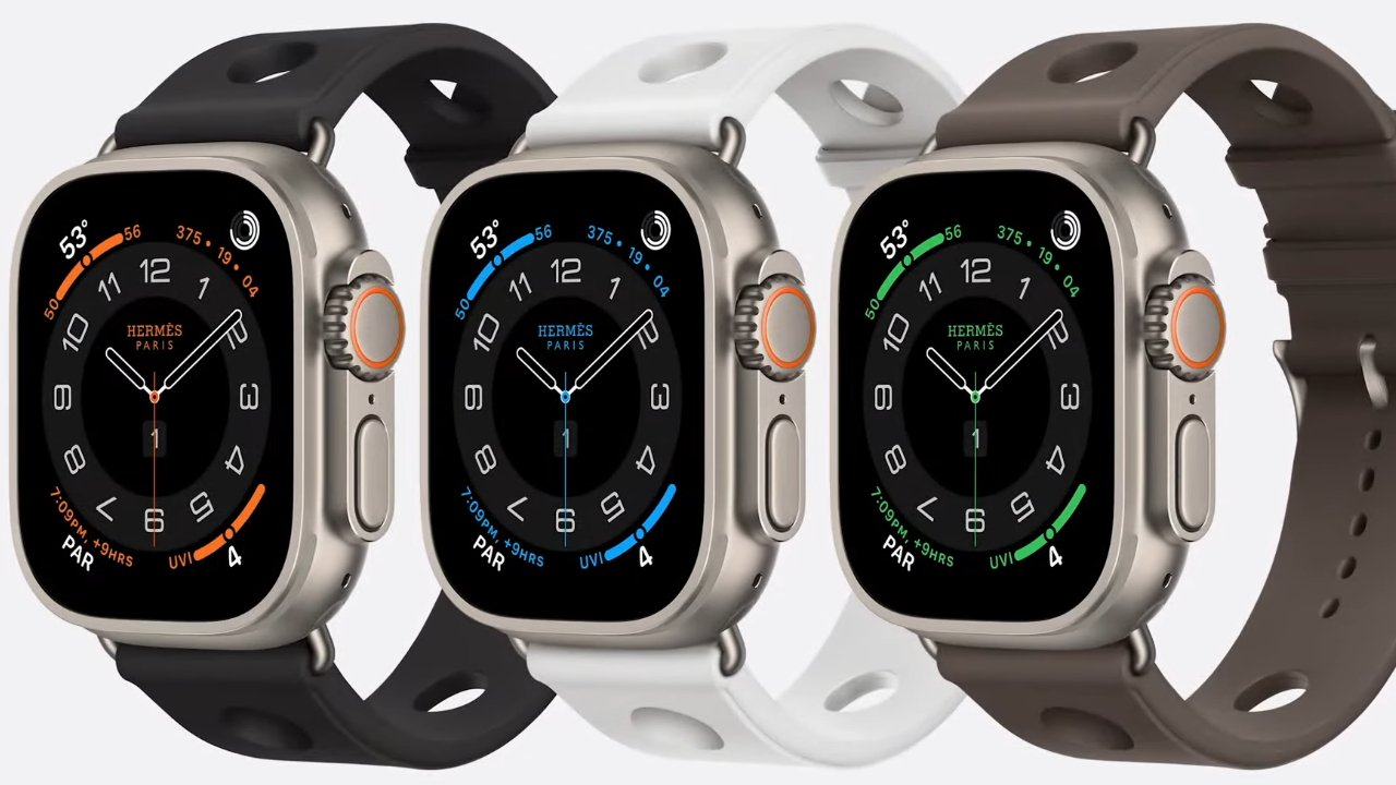 Three smartwatches with circular displays and different colored bands in black, white, and brown, each showing a different color accent on the display.
